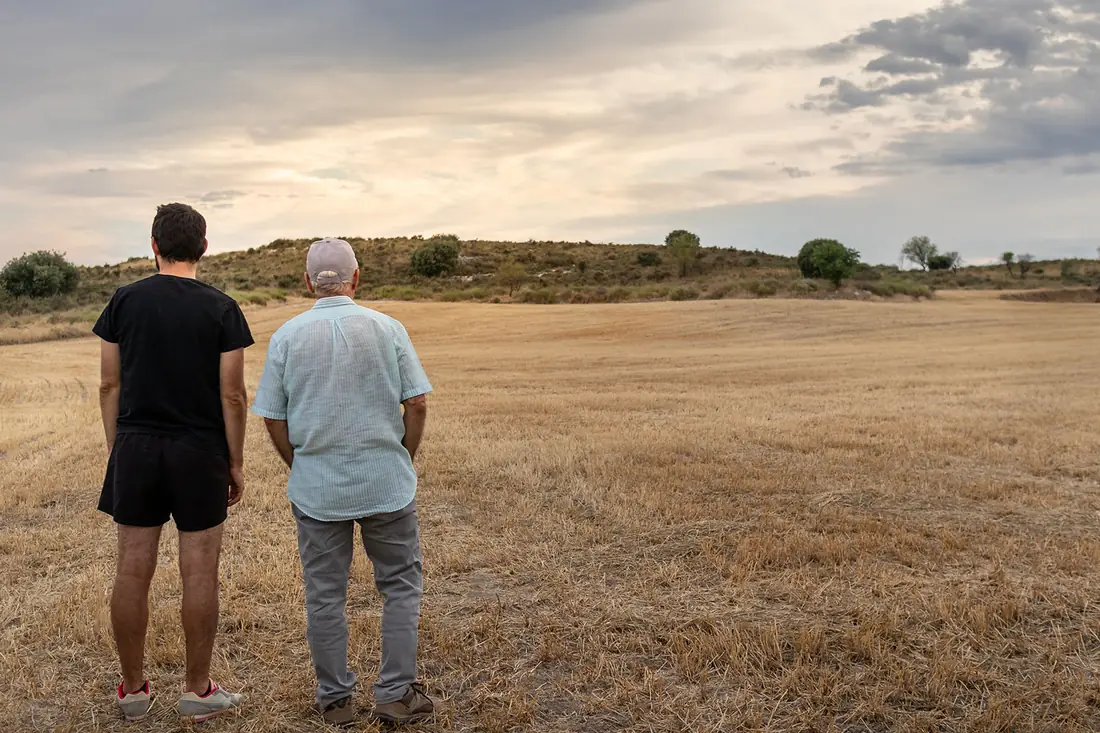 Two generations of a family business looking out over their land.
